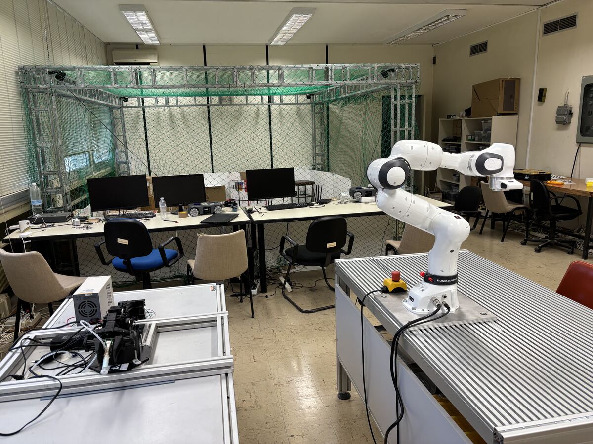 Robotics laboratory with robot arms and workstations